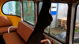 Stinky black pantyhose feet in old school bus foot wors