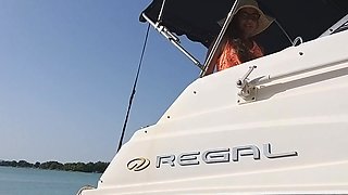 Horny milf brunette rides a transmission box with both of her holes in a boat in public