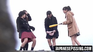 Hairy Japanese babes pee in nature while being watched by lucky voyeur