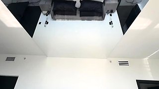 In a kitchen a sexy brunette playing with her big boobs