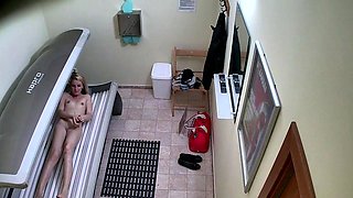 Blonde plays with her pussy in solarium