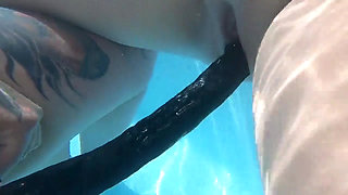 Camilla and Cheyenne Play with a double ended dildo in the pool