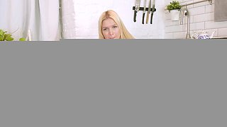 Blonde babe Jessica Alessandra pleasures her smooth pussy in the kitchen