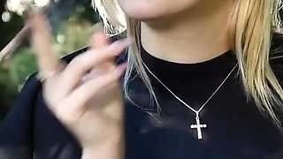 Hot Blonde Babe Smoking Two Black Cigarettes in Nature