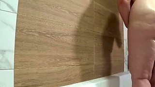 Bathroom spy cam captures plump MILF with big natural tits showering and fingering her hairy pussy - PAWG amateur homemade